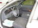 2001 Ford Crown Victoria - The interior of a 2001 Ford Crown Victoria is visible, including the dashboard, steering wheel, and seats.