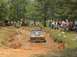 1972 Ford Bronco - Off-road vehicle struggling in a mud pit during an event, with onlookers gathered.
