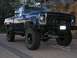 1979 Chevrolet C/K Pickup - A lifted blue pickup truck with "DREAM ON" visible on the windshield.
