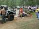 1972 Ford Bronco - A camouflaged 1972 Ford Bronco navigates a muddy off-road course with spectators watching.