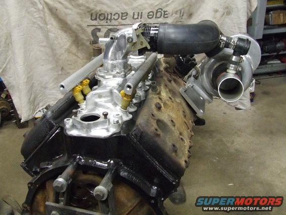 Turbocharged V8 engine block with intake manifold and turbocharger attached