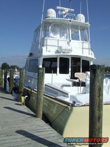 Yacht docked at pier, showing side and cabin
