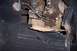 1976 Ford Bronco - Significant rust damage is visible on the floor pan and transmission tunnel, obscuring vehicle identification.