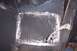1976 Ford Bronco - Close-up view of a welded floor pan repair, showing metalwork and a seatbelt strap attached to the side.