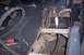 1976 Ford Bronco - This photo shows the underside of a vehicle undergoing repair, focusing on the frame and suspension system.