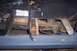 1976 Ford Bronco - The interior floor pan of a vehicle is shown with the chassis and wiring exposed, indicating rust and ongoing repair.