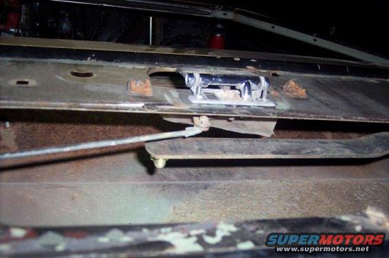 tailgate latch mechanism with rusted metal and a cable