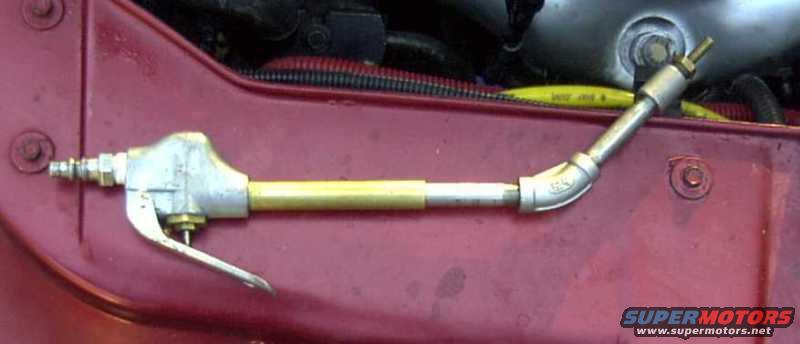 Red car fender with an air tool attached to the engine bay