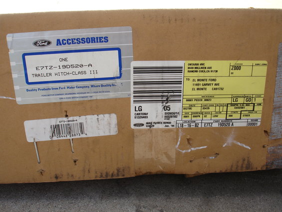 Box with Ford accessories label for a trailer hitch, part number E7TZ-19D520-A, and shipping labels
