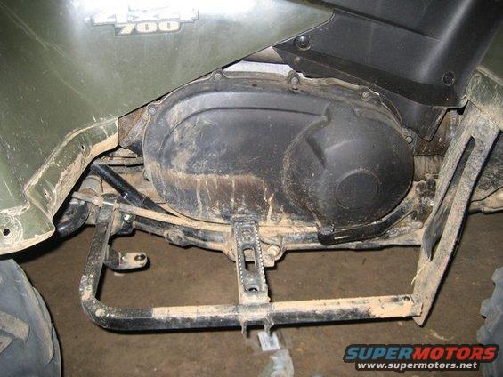 Close-up of a 2007 Suzuki King Quad 700's engine cover and footpeg. The '4x4 700' badge is visible
