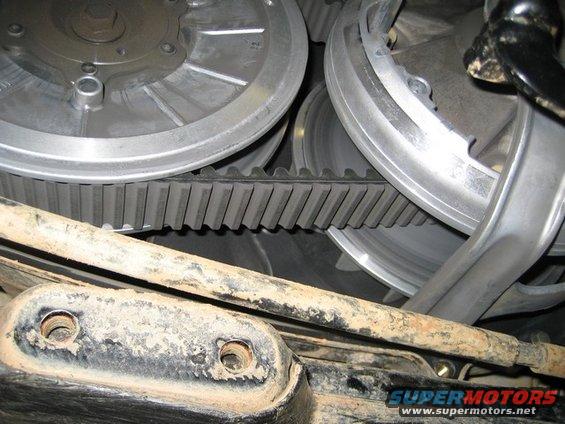 Close-up of ATV CVT belt and pulleys. Bottom part shows rusty metal and mounting holes