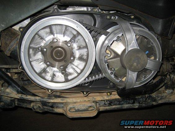 ATV CVT drive and driven clutch with belt, viewed from below. The metal components are dusty