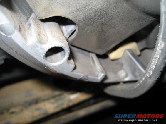 Close-up of a metal casting with a cylindrical hole, possibly part of an engine or transmission