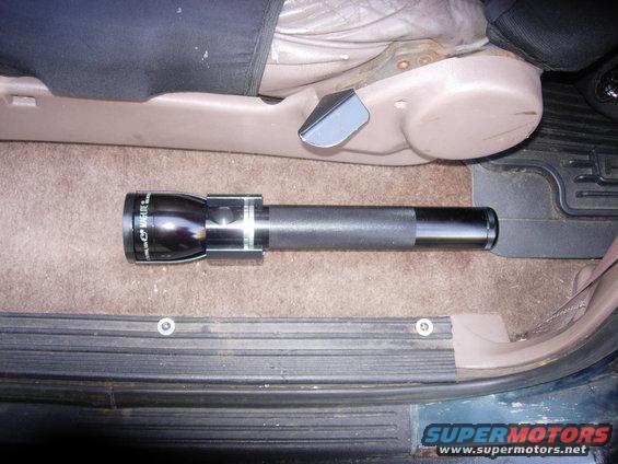 Maglite flashlight on vehicle floor