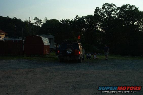 1993 Ford Bronco parked outside with people gathered nearby
