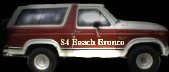 Side view of a red and white Ford Bronco with "S-4 Beach Bronco" text