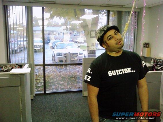Man wearing a black t-shirt with "SUICIDE.." printed on it, with a noose around his neck