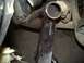 1979 Ford Bronco - Close-up of exhaust pipe and frame component with stamped part number.