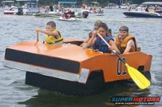 Orange boat resembling a car with children aboard on a lake