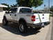2005 Ford F-150 - This lifted Ford F-150 pickup truck is shown from the rear quarter angle, with FX4 badging visible on the side.