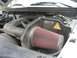 2005 Ford F-150 - Aftermarket Airaid air intake system installed in the engine bay.