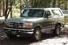 1996 Ford Bronco - This 1996 Ford Bronco is parked on a dirt path surrounded by trees.