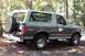 1996 Ford Bronco - A 1996 Ford Bronco is parked outdoors with trees in the background.