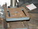 1978 Ford Ranchero - A close-up view of a drill press table with two brass bushings on its surface.