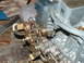 1978 Ford Ranchero - Carburetor linkage detail, showing springs and levers on a metal part.