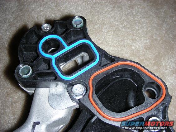 Close-up of intake manifold gaskets with blue and orange seals