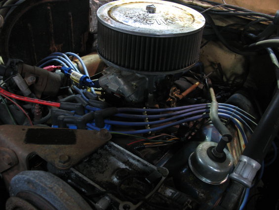 Engine bay showing air cleaner, carburetor, spark plug wires, and fuel filter