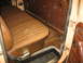 1978 Ford F-250 - The interior of a truck shows a worn brown bench seat and the lower section of the door panel.