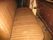 1978 Ford F-250 - Interior view of a vehicle's bench seat, showing the brown upholstery and seatbelts.