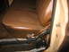 1978 Ford F-250 - Interior view of a vehicle's bench seat and door jamb, showing worn brown vinyl upholstery and chrome accents.