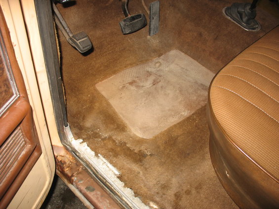 1978 Ford F-250 interior driver's side floorboard with brown carpet and pedals