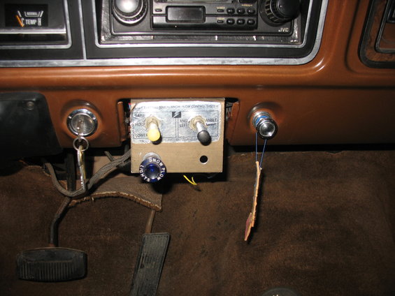 1978 Ford F-250 interior showing aftermarket snow plow controls with toggle switches and a blue button labeled SNOW PLOW LIGHTS