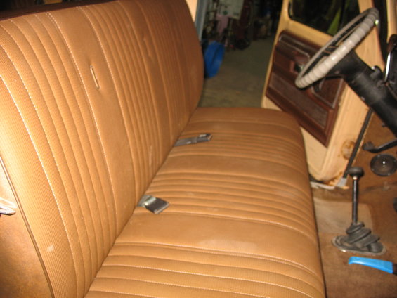 Brown vinyl bench seat and steering wheel inside a 1973 Ford F-Series truck