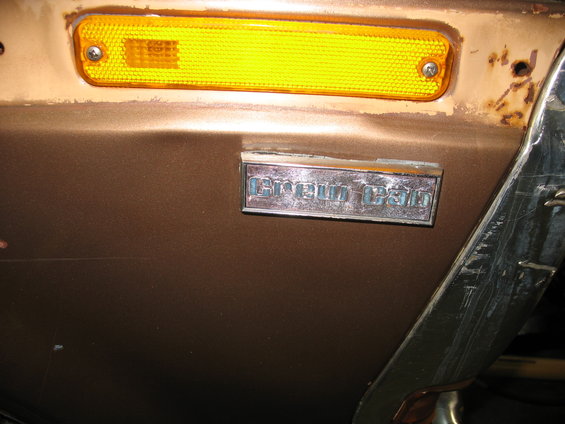 Brown truck fender with amber marker light and 'F-250' badge
