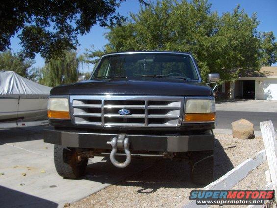 Ford truck front view with aftermarket bumper and tow hook