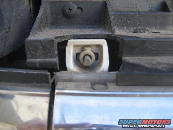 Headlight mounting bracket with chrome trim
