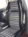 1978 Ford Bronco - Interior view of vehicle seats with distinctive striped fabric pattern.