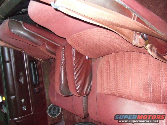 Red velour seats and brown leather interior trim of a vehicle