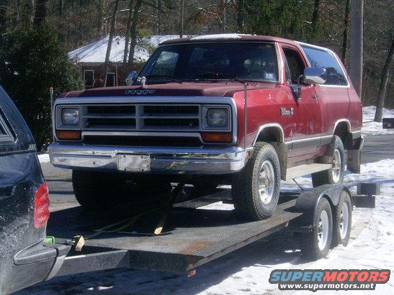 Red Dodge Ramcharger on a trailer. Dodge nameplate on grille