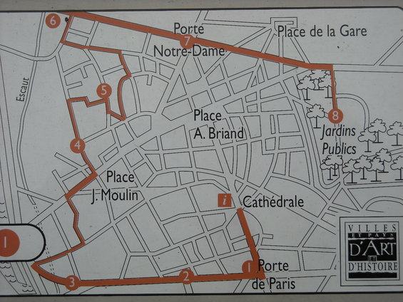 Map of a city with a marked walking route, showing streets, squares, and landmarks like Notre-Dame and the train station