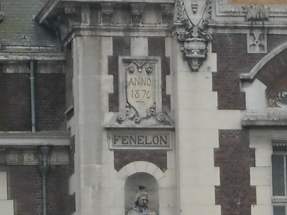 Building facade with "ANNO 1876" and "FENELON" inscriptions above a statue