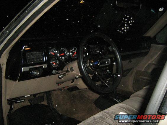 1988 Mercury Grand Marquis interior with aftermarket gauges and dice hanging from mirror