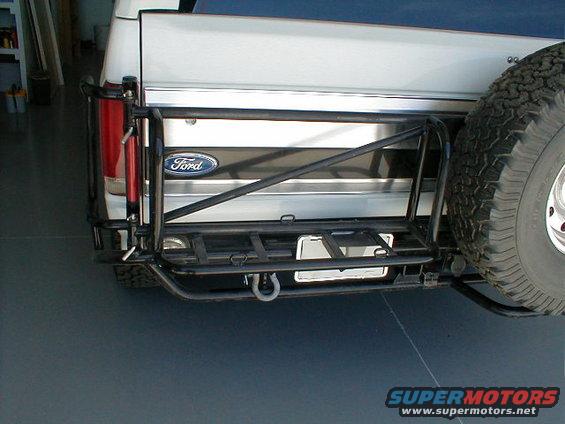 Rear of a white 1984 Ford Bronco with spare tire and custom bumper