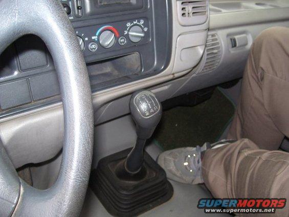 Interior view of a 1995 GMC Sierra 1500 with manual transmission shifter and dashboard controls