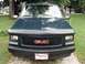 1995 GMC Sierra 1500 - Front view of a dark green 1995 GMC Sierra 1500, showing the grille and headlights.