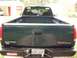 1995 GMC Sierra 1500 - Rear view of a dark green 1995 GMC Sierra pickup truck, showing the tailgate and bumper with a Kansas license plate.